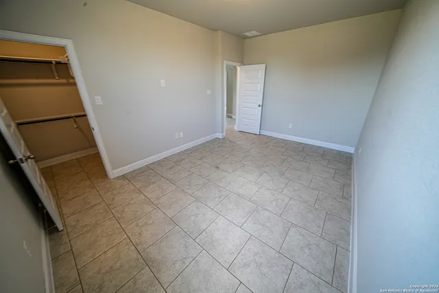 a view of an empty room and wooden floor