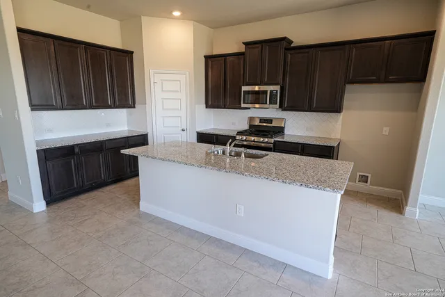 a kitchen with stainless steel appliances a refrigerator and a stove