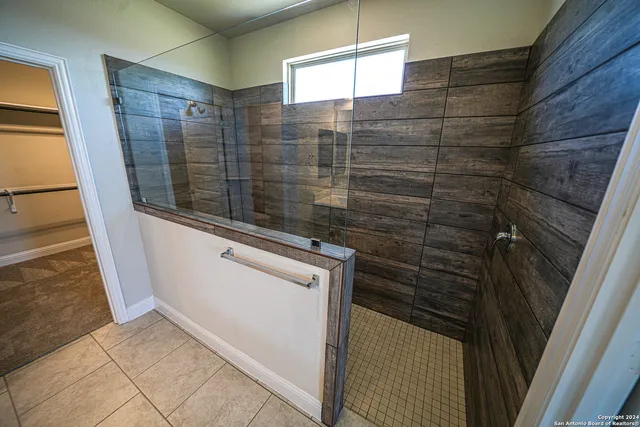 a bathroom with a shower and a sink