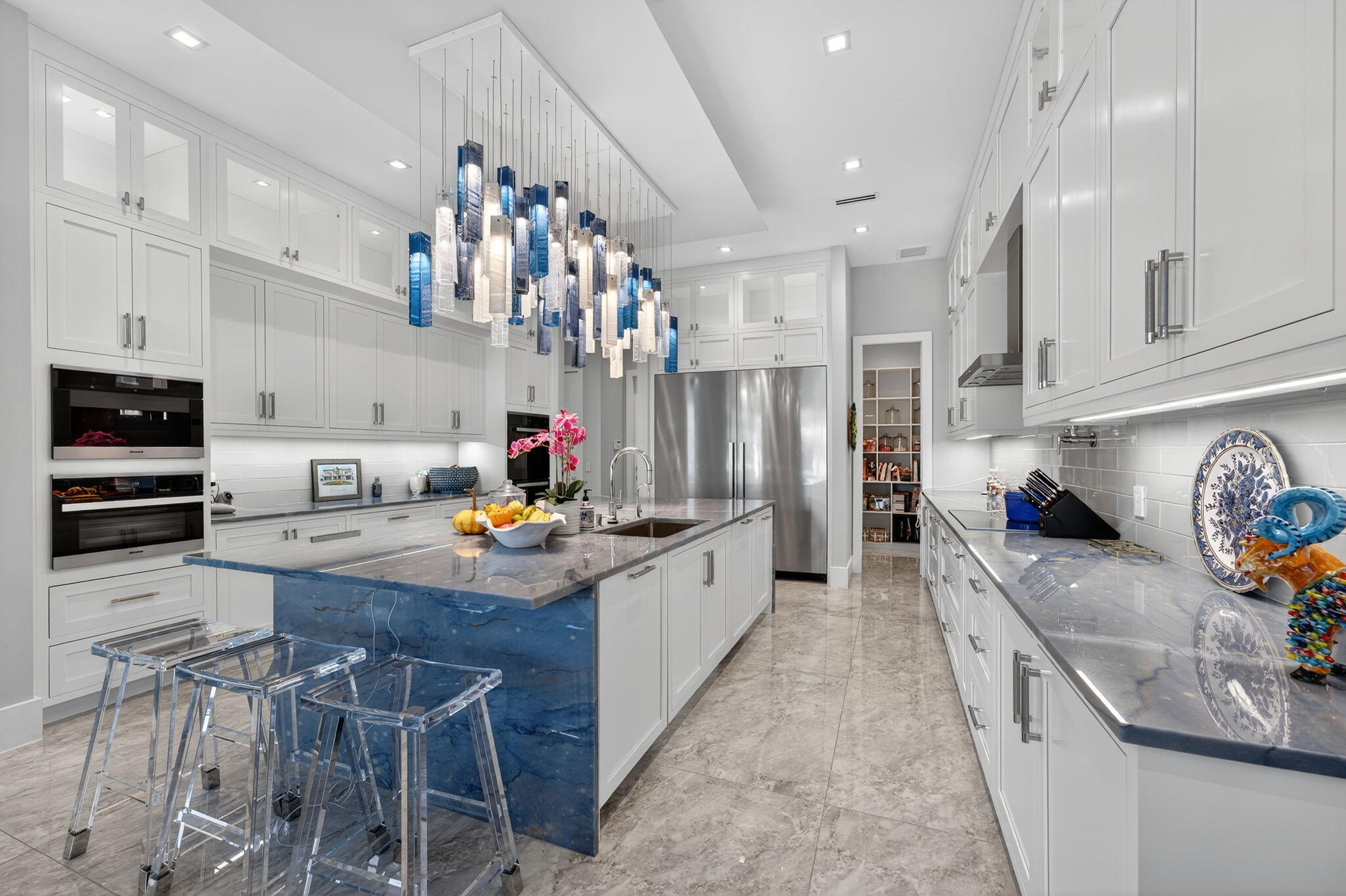 785 Northeast 70th Street Boca Raton, FL 33487 - Photo 21 of 83 a kitchen with stainless steel appliances granite countertop a sink stove and refrigerator