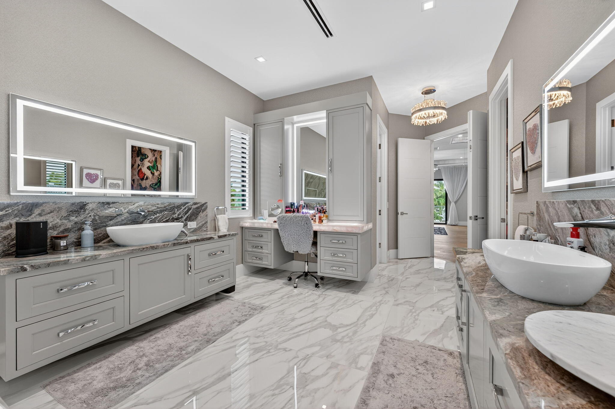 785 Northeast 70th Street Boca Raton, FL 33487 - Photo 34 of 83 a spacious bathroom with a double vanity sink a mirror a toilet and a window