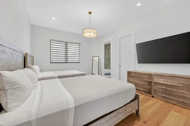 an aerial view of multiple houses with a yard