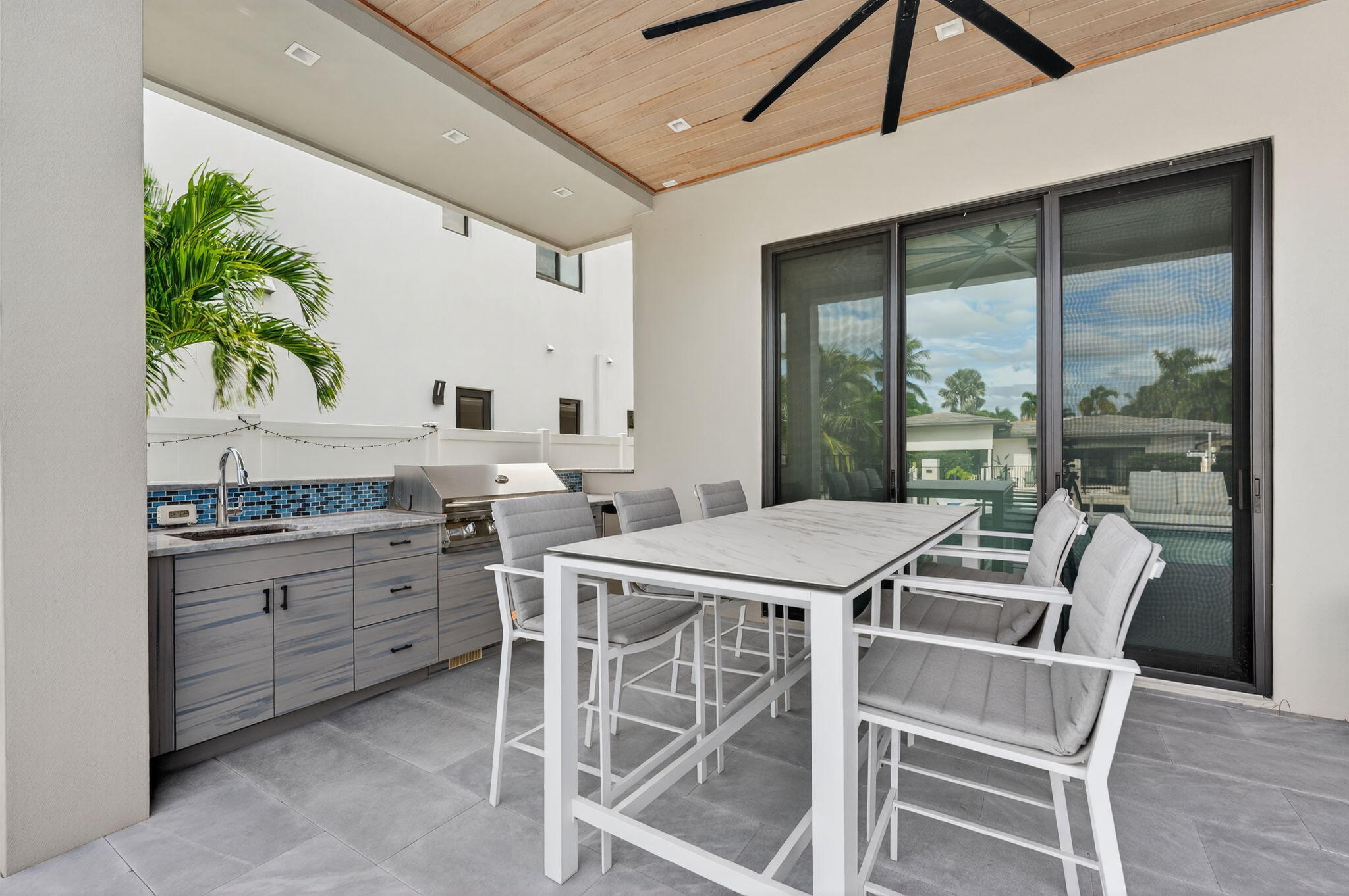 785 Northeast 70th Street Boca Raton, FL 33487 - Photo 64 of 83 a kitchen with a table chairs sink and cabinets