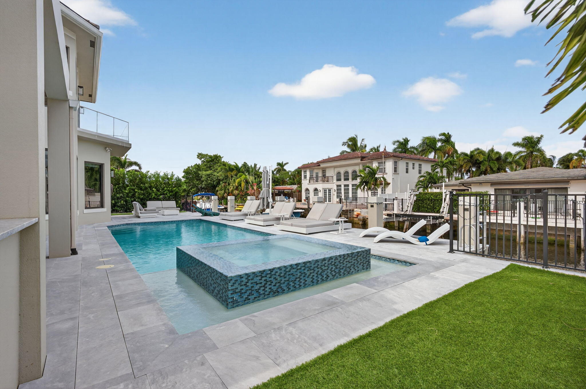 785 Northeast 70th Street Boca Raton, FL 33487 - Photo 65 of 83 a view of a swimming pool with a patio and a yard