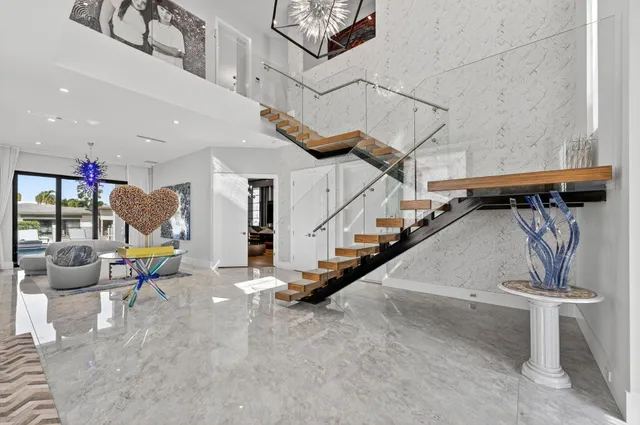 a view of kitchen island with stainless steel appliances granite countertop a stove and a sink