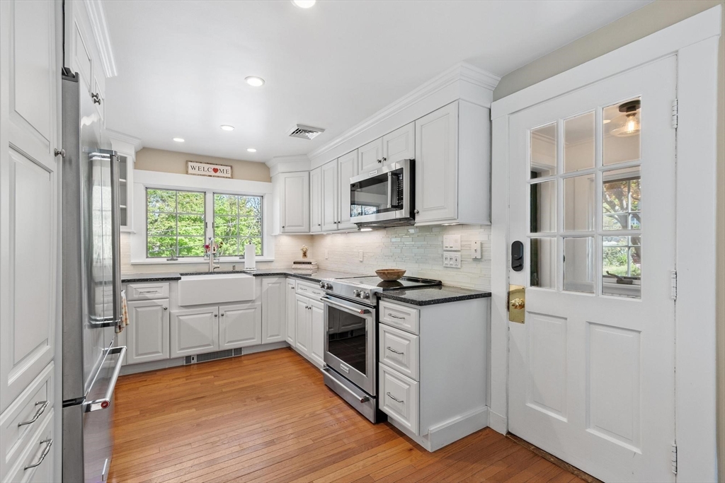 25 Naples Road Melrose, MA 02176 - Photo 11 of 36 a kitchen with a stove a sink and a window