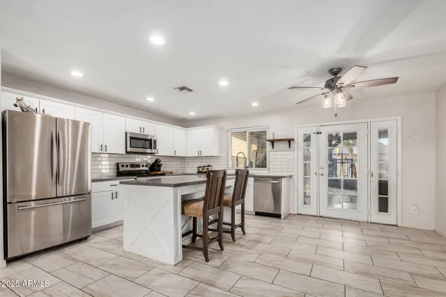 a kitchen with refrigerator and cabinets