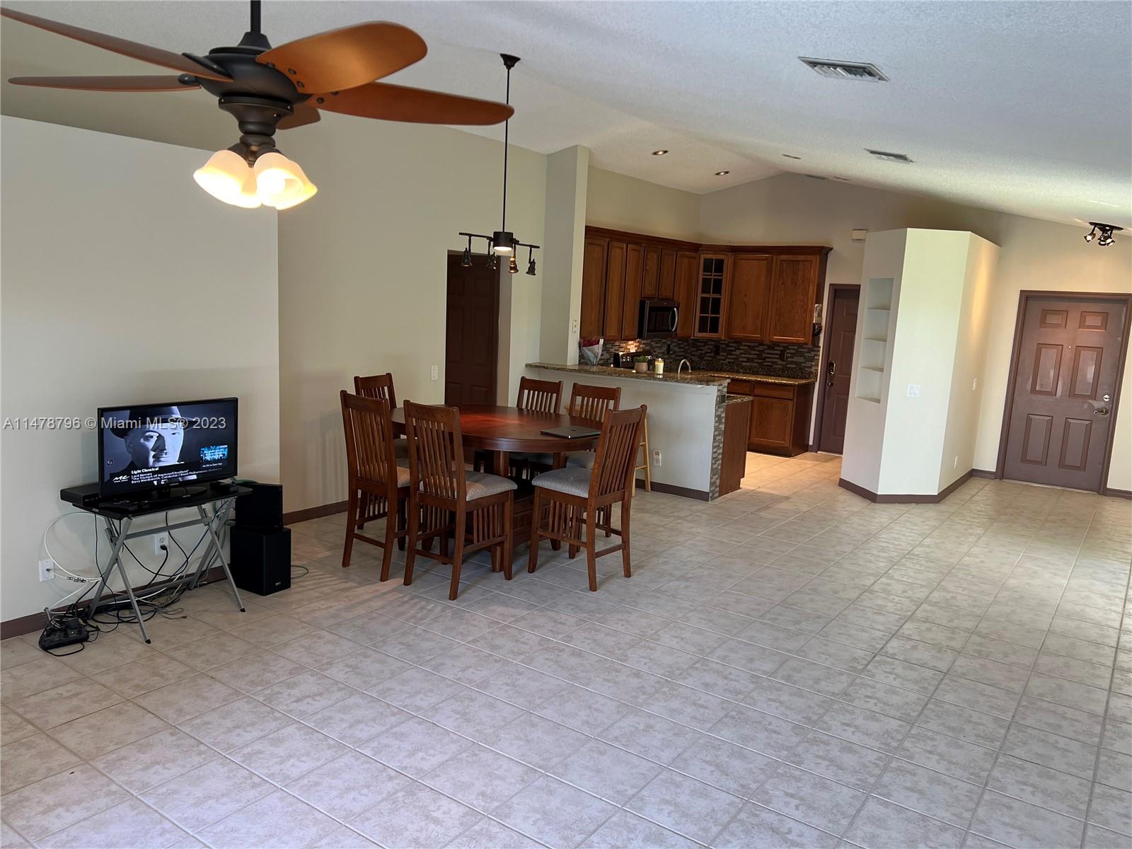 1135 Areca Way Weston, FL 33327 - Photo 11 of 45 a view of a living room and dining room
