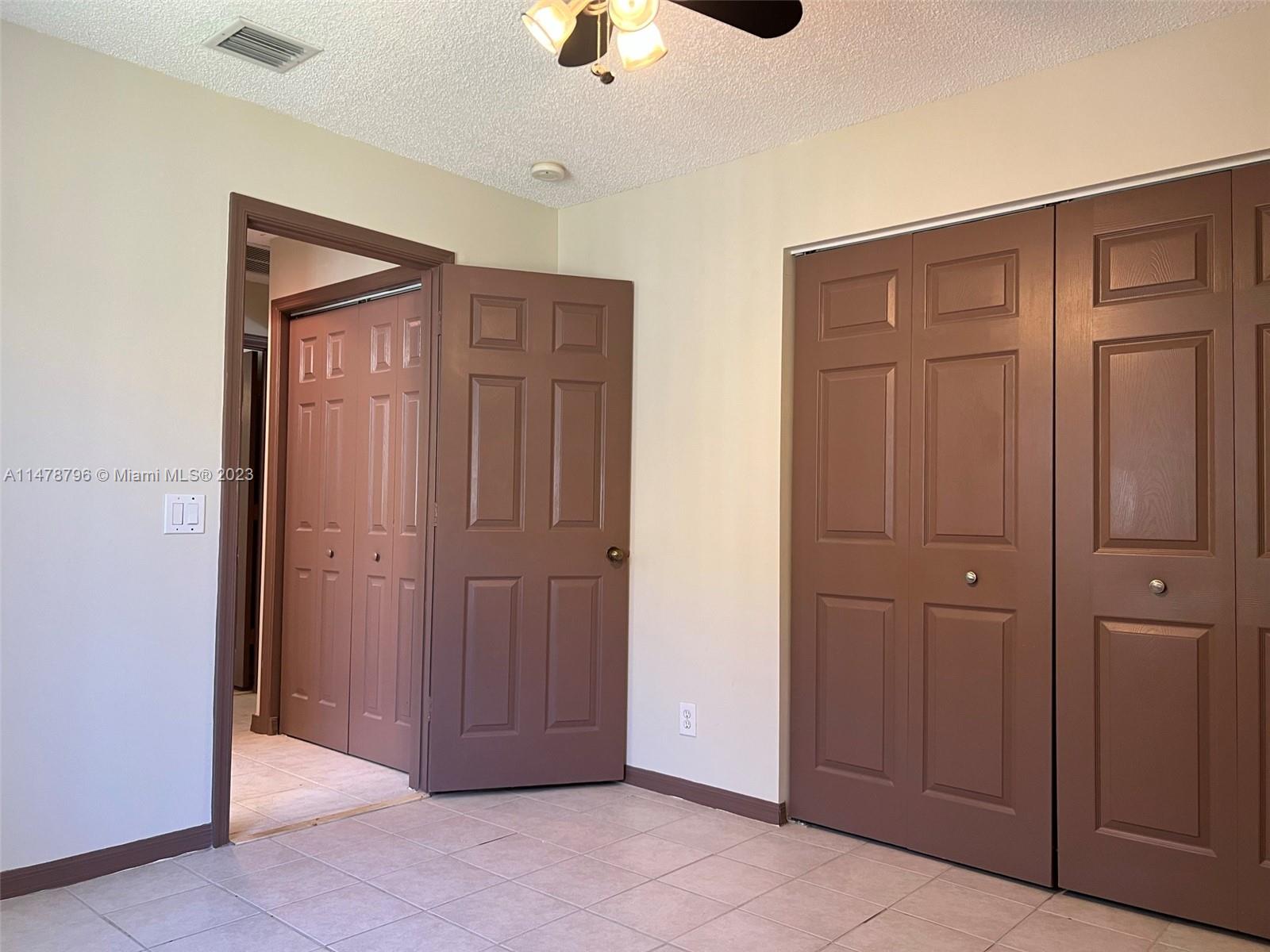 1135 Areca Way Weston, FL 33327 - Photo 19 of 45 an empty room with closet and windows