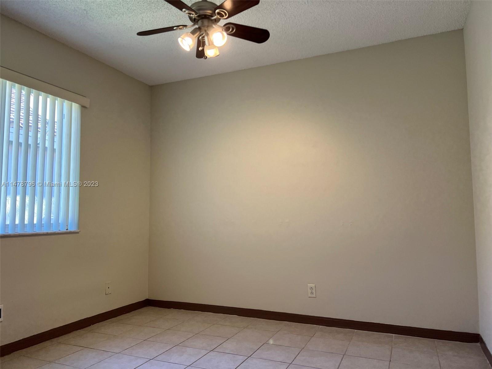 1135 Areca Way Weston, FL 33327 - Photo 21 of 45 an empty room with a window