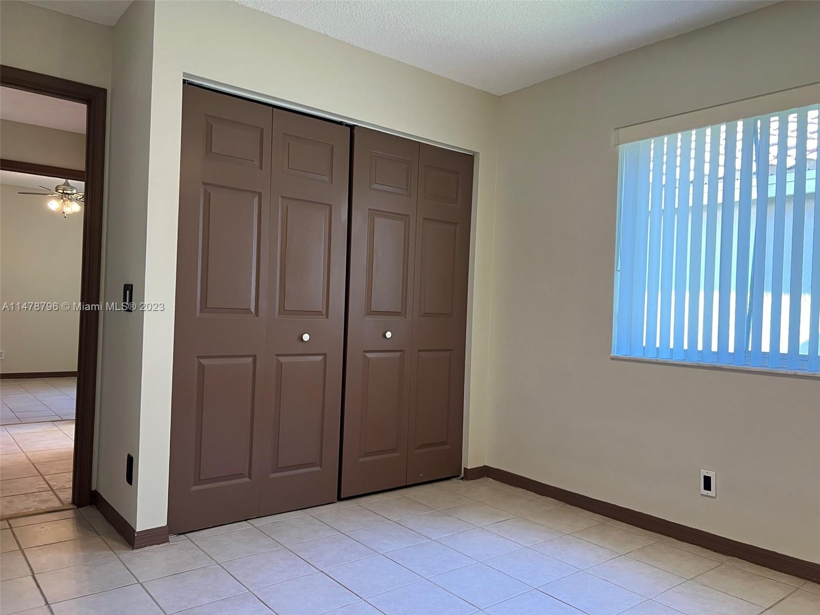 1135 Areca Way Weston, FL 33327 - Photo 22 of 45 a view of an empty room with window