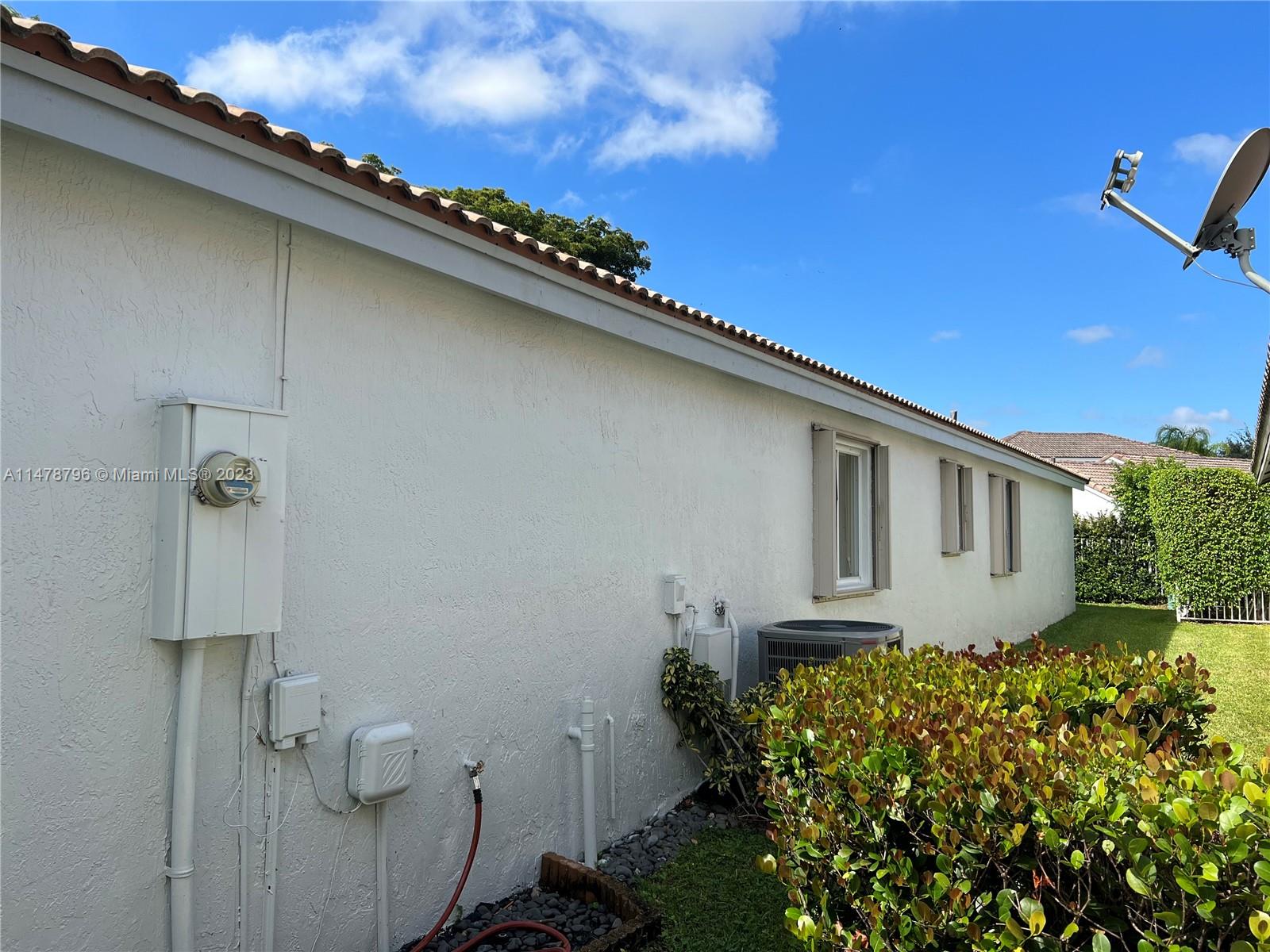 1135 Areca Way Weston, FL 33327 - Photo 3 of 45 a front view of a house with garden