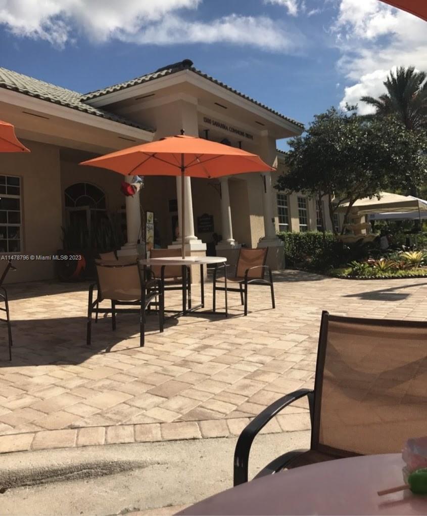 1135 Areca Way Weston, FL 33327 - Photo 37 of 45 a view of pool with chairs and tables