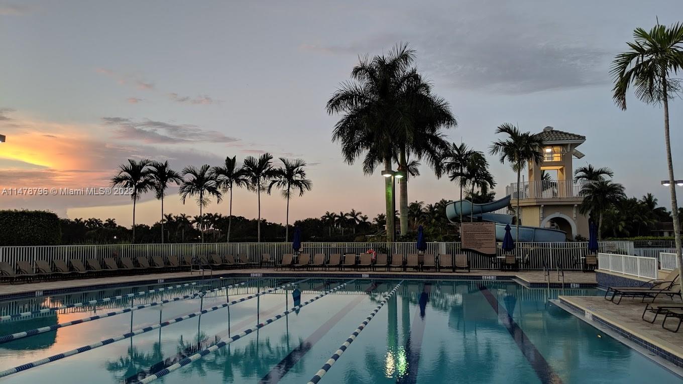1135 Areca Way Weston, FL 33327 - Photo 40 of 45 a view of swimming pool with a table and chairs