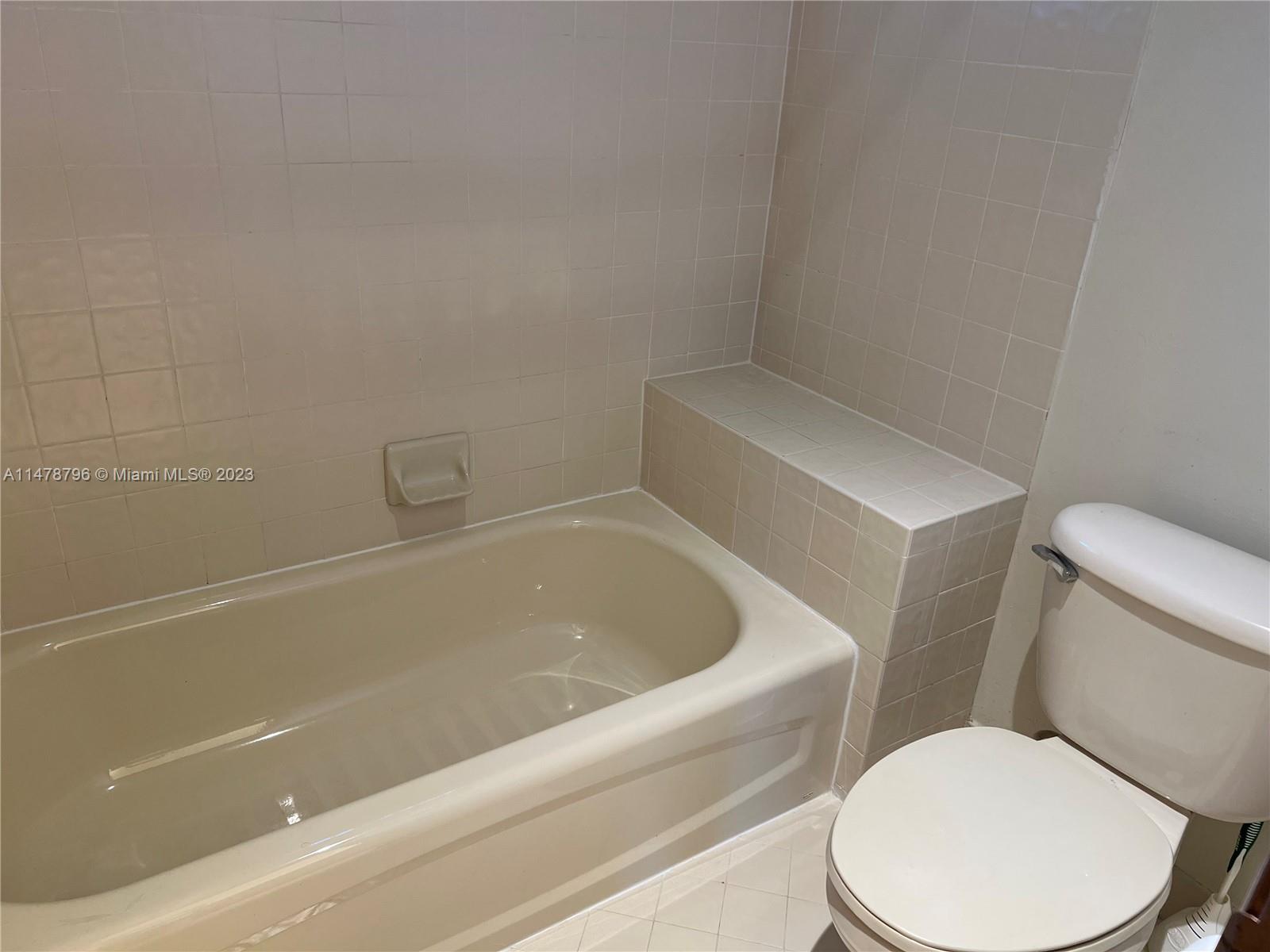 1135 Areca Way Weston, FL 33327 - Photo 5 of 45 a white toilet sitting next to a bath tub