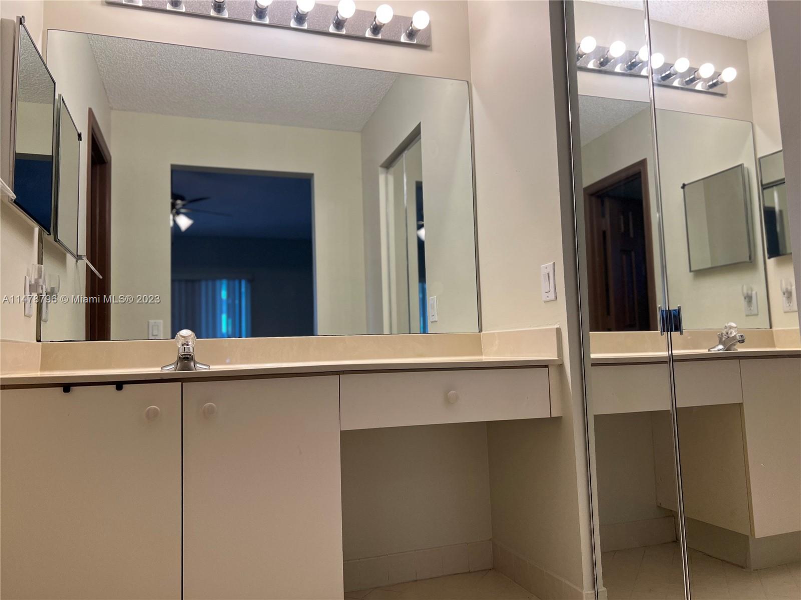 1135 Areca Way Weston, FL 33327 - Photo 6 of 45 a bathroom with a sink and a mirror