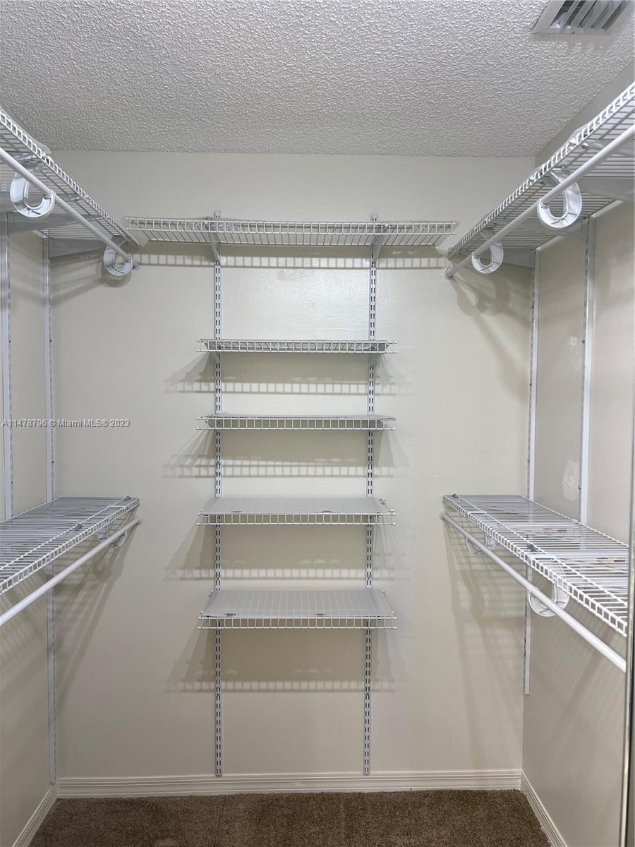 1135 Areca Way Weston, FL 33327 - Photo 7 of 45 a view of a room with racks on the wall