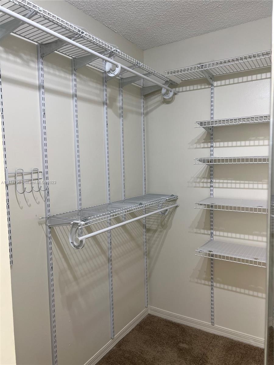 1135 Areca Way Weston, FL 33327 - Photo 8 of 45 a view of a room with racks on the wall