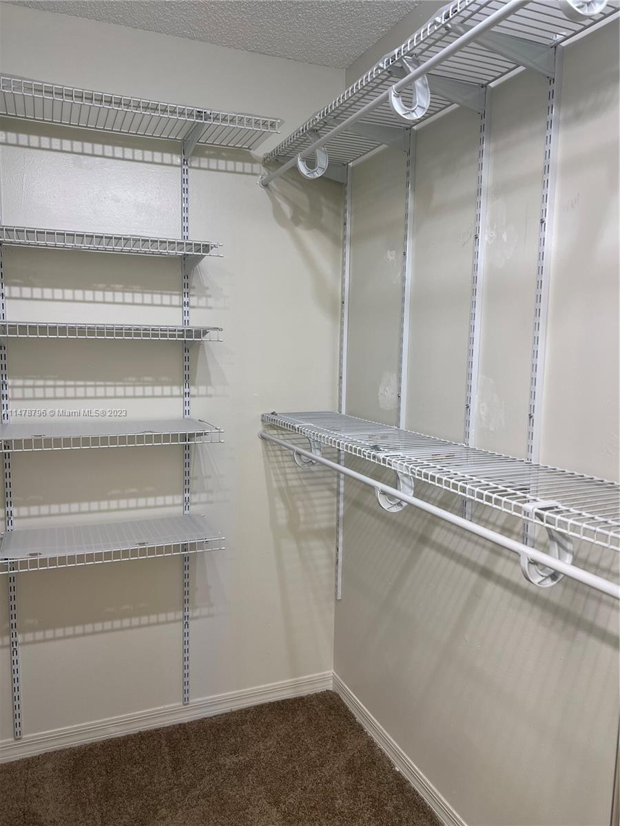 1135 Areca Way Weston, FL 33327 - Photo 9 of 45 a view of a room with rack on the wall
