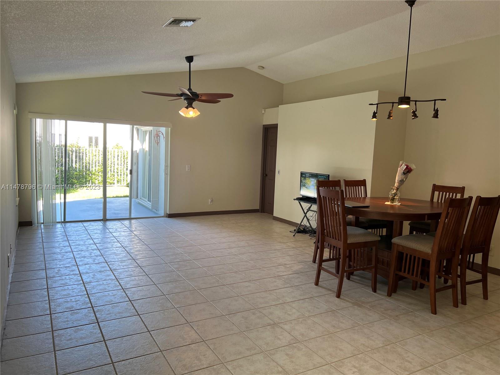 1135 Areca Way Weston, FL 33327 - Photo 10 of 45 a view of a dining room with furniture
