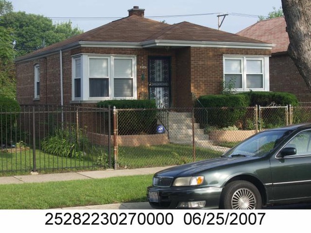 12142 South State Street Chicago, IL 60628 - Photo 1 of 1 a front view of a house with a yard