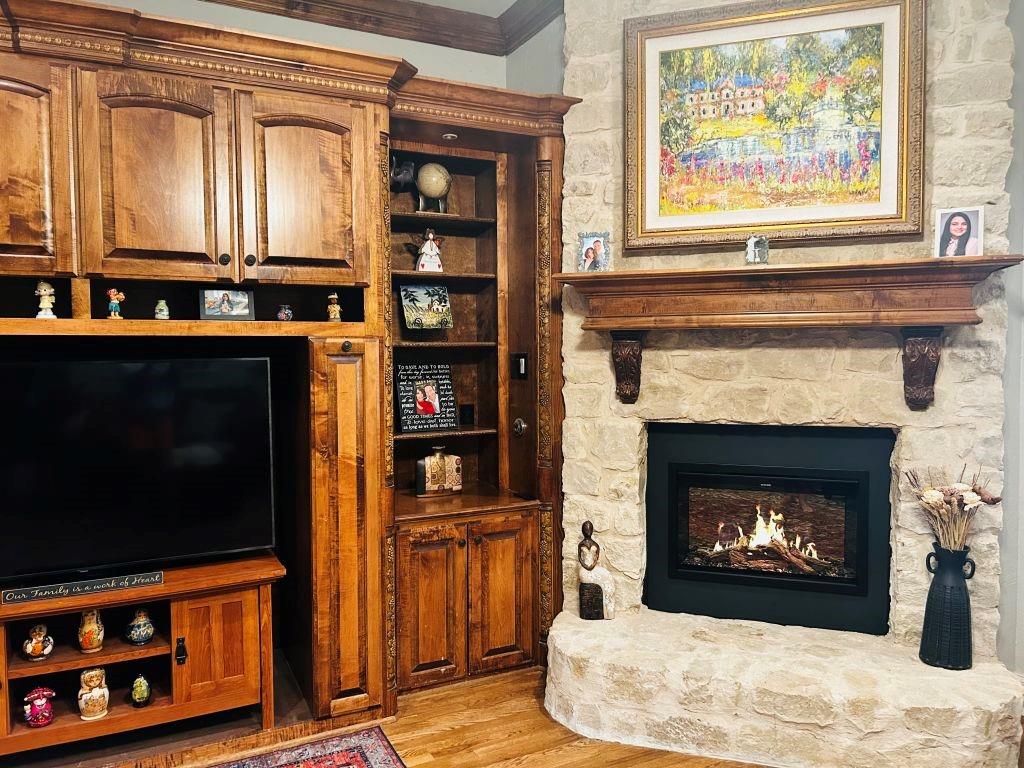 620 Highview Lane Hurst, TX 76054 - Photo 15 of 40 a living room with fireplace and a wooden floor