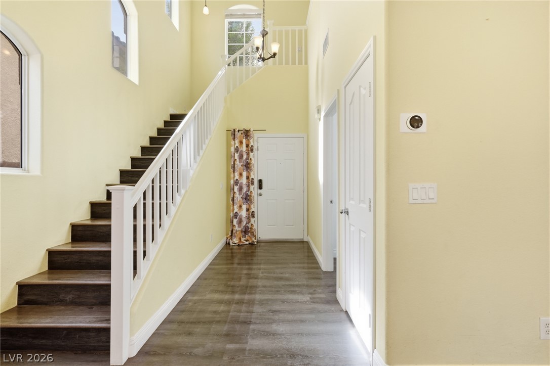 8932 Caledon Ridge Court Las Vegas, NV 89149 - Photo 14 of 39 An airy entrance foyer showcases vaulted ceilings and rich wood-toned flooring.