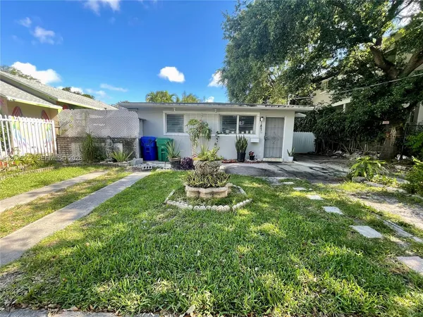 a view of a house with backyard sitting area and garden