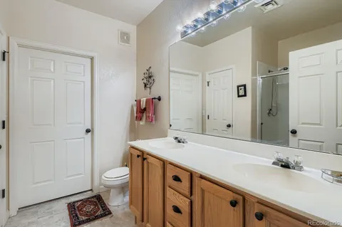a spacious bathroom with a sink double vanity and a toilet