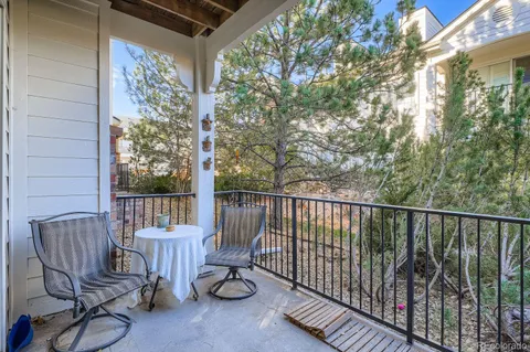 a view of a chair and table in the balcony