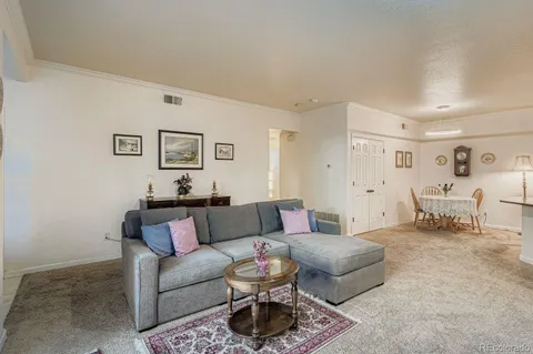 a living room with furniture and a lamp