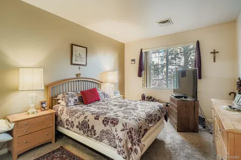 a bedroom with a large bed and a window