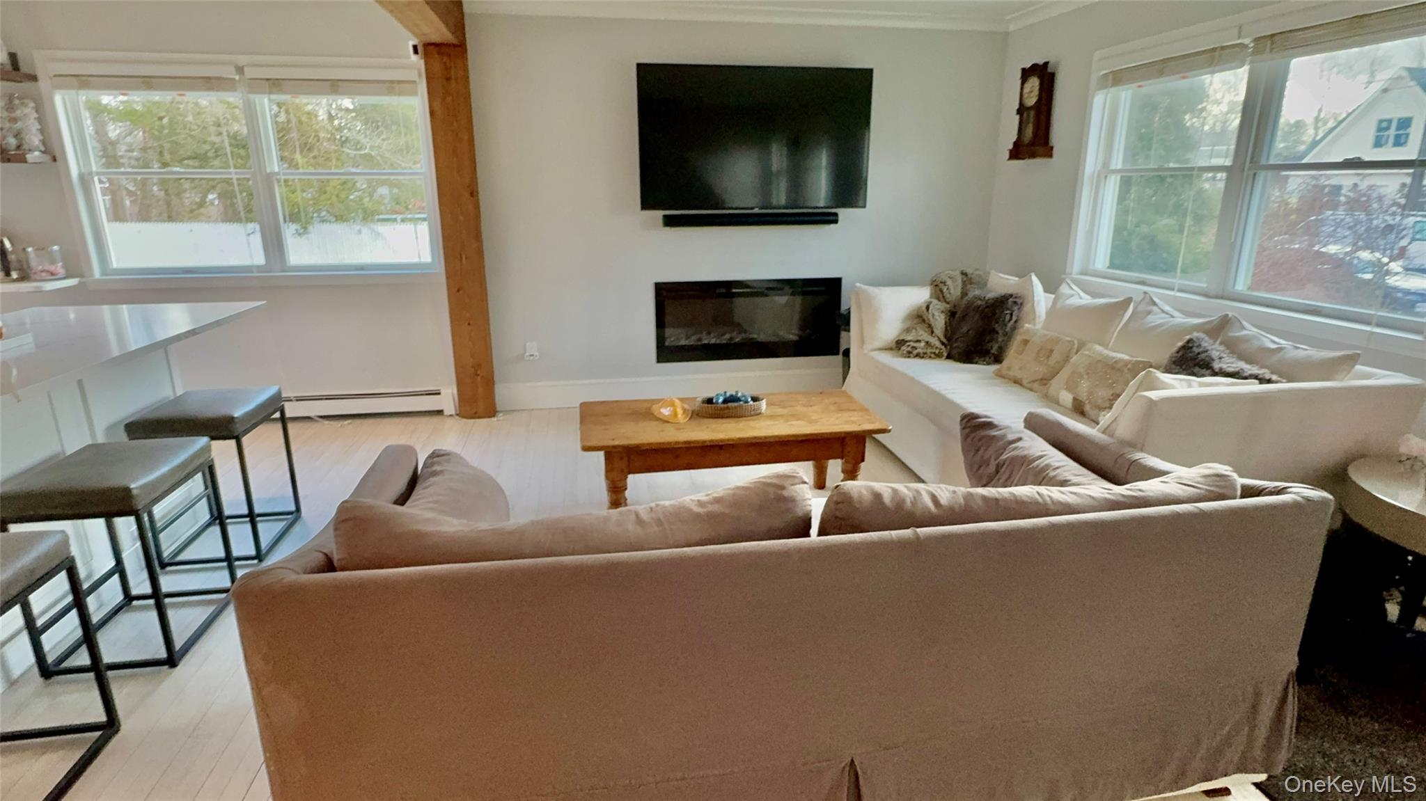 4 North Westbury Road Hampton Bays, NY 11946 - Photo 11 of 20 a living room with furniture and a flat screen tv