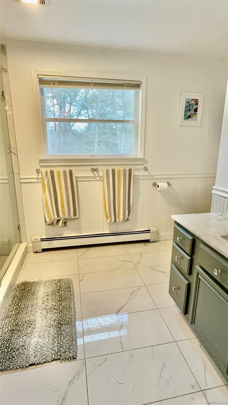 4 North Westbury Road Hampton Bays, NY 11946 - Photo 14 of 20 a bathroom with a sink and a window