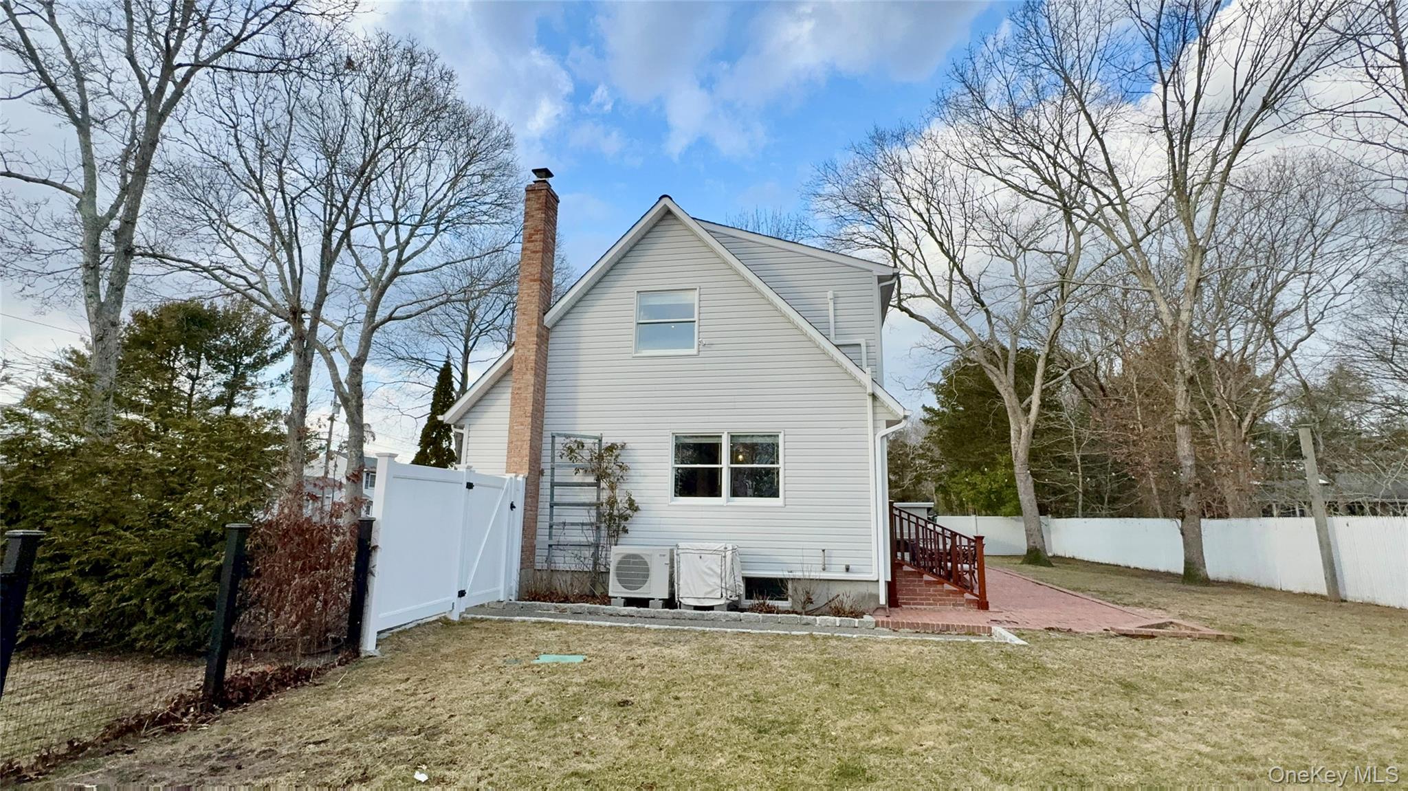 4 North Westbury Road Hampton Bays, NY 11946 - Photo 19 of 20 a view of a house with a yard covered in snow
