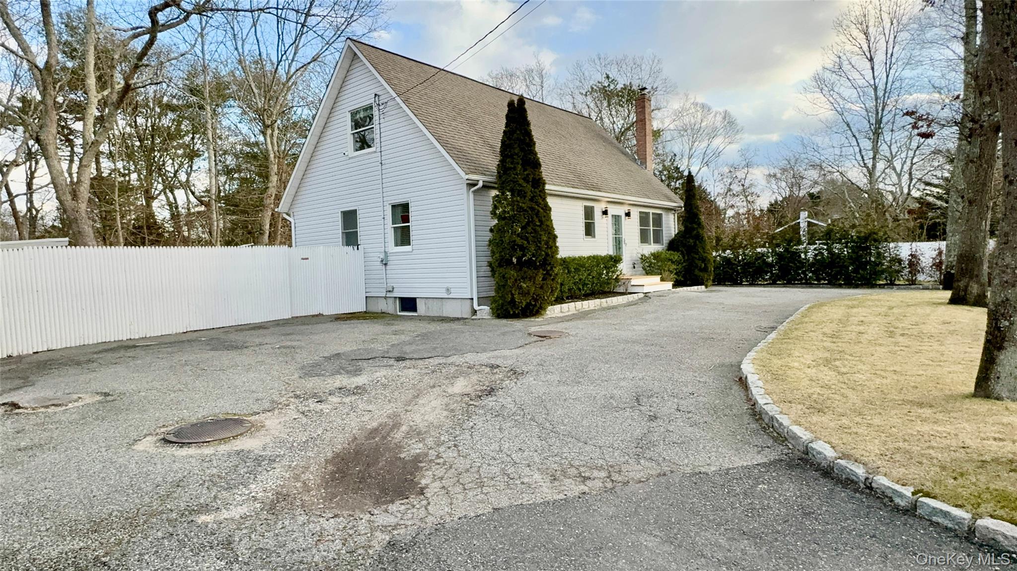 4 North Westbury Road Hampton Bays, NY 11946 - Photo 20 of 20 a view of a white house with a yard