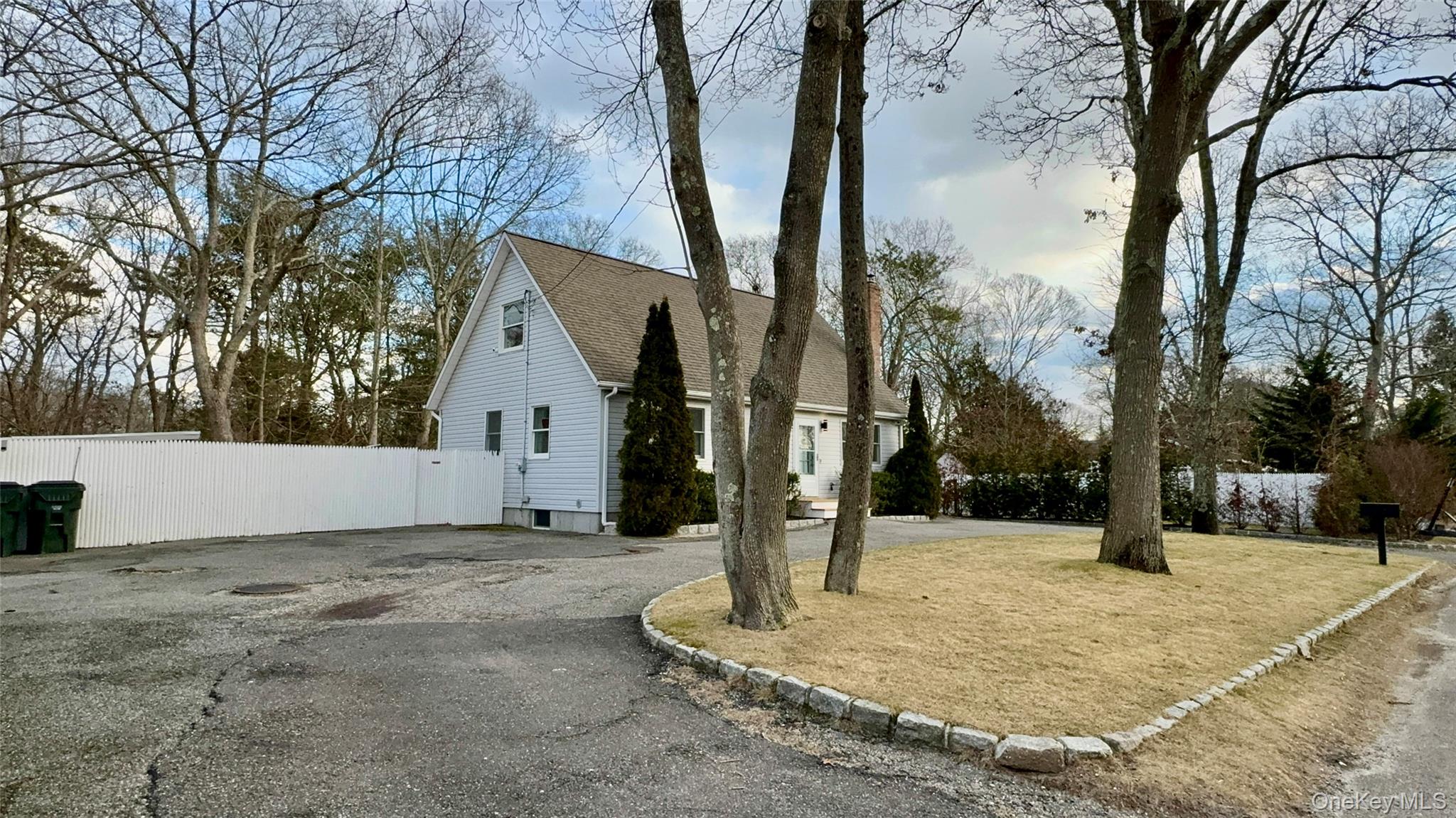 4 North Westbury Road Hampton Bays, NY 11946 - Photo 3 of 20 a view of a white house with a yard and tree