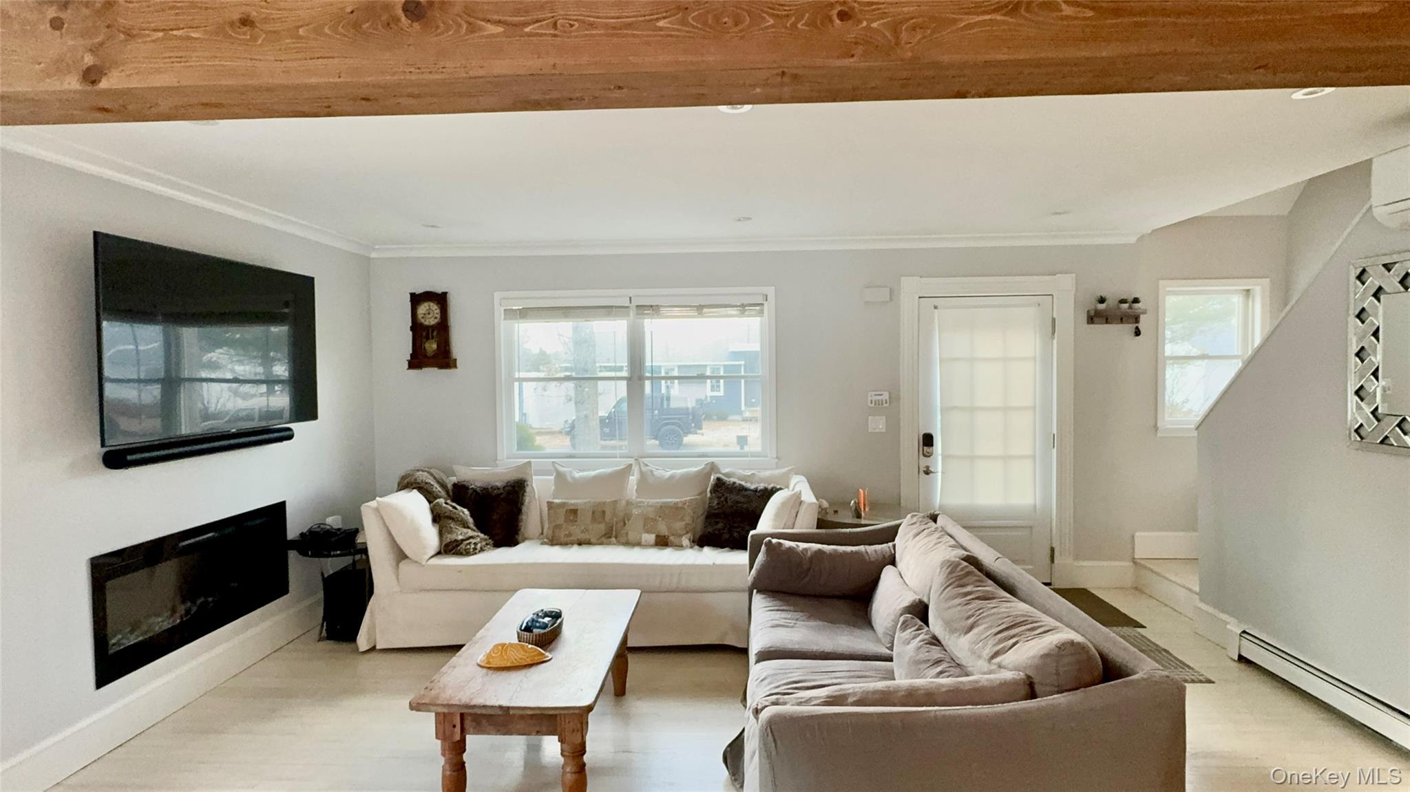 4 North Westbury Road Hampton Bays, NY 11946 - Photo 6 of 20 a living room with furniture and a fireplace