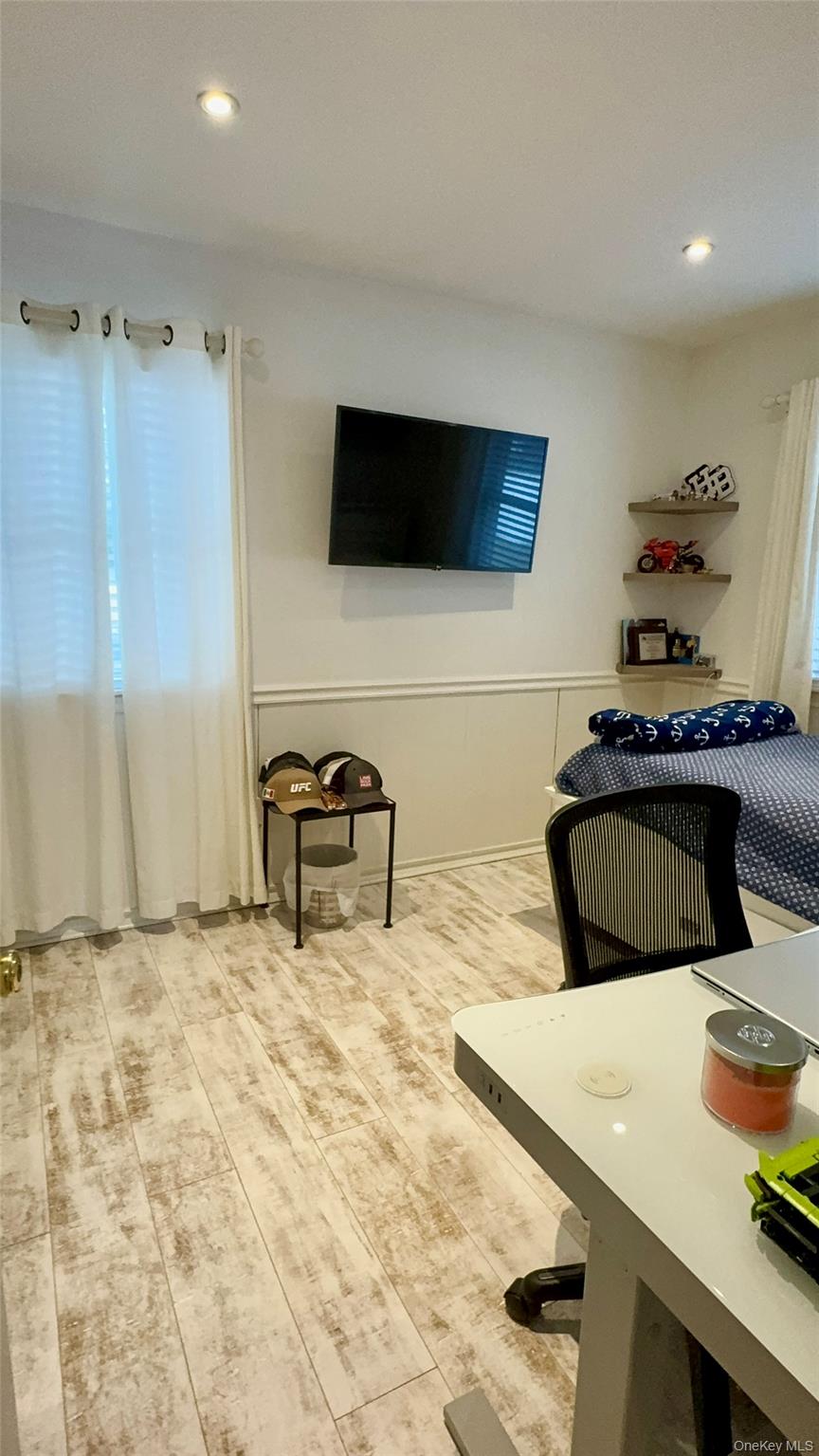 4 North Westbury Road Hampton Bays, NY 11946 - Photo 8 of 20 a living room with furniture and a flat screen tv