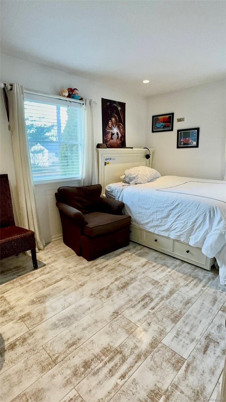 4 North Westbury Road Hampton Bays, NY 11946 - Photo 9 of 20 a bedroom with a bed and window