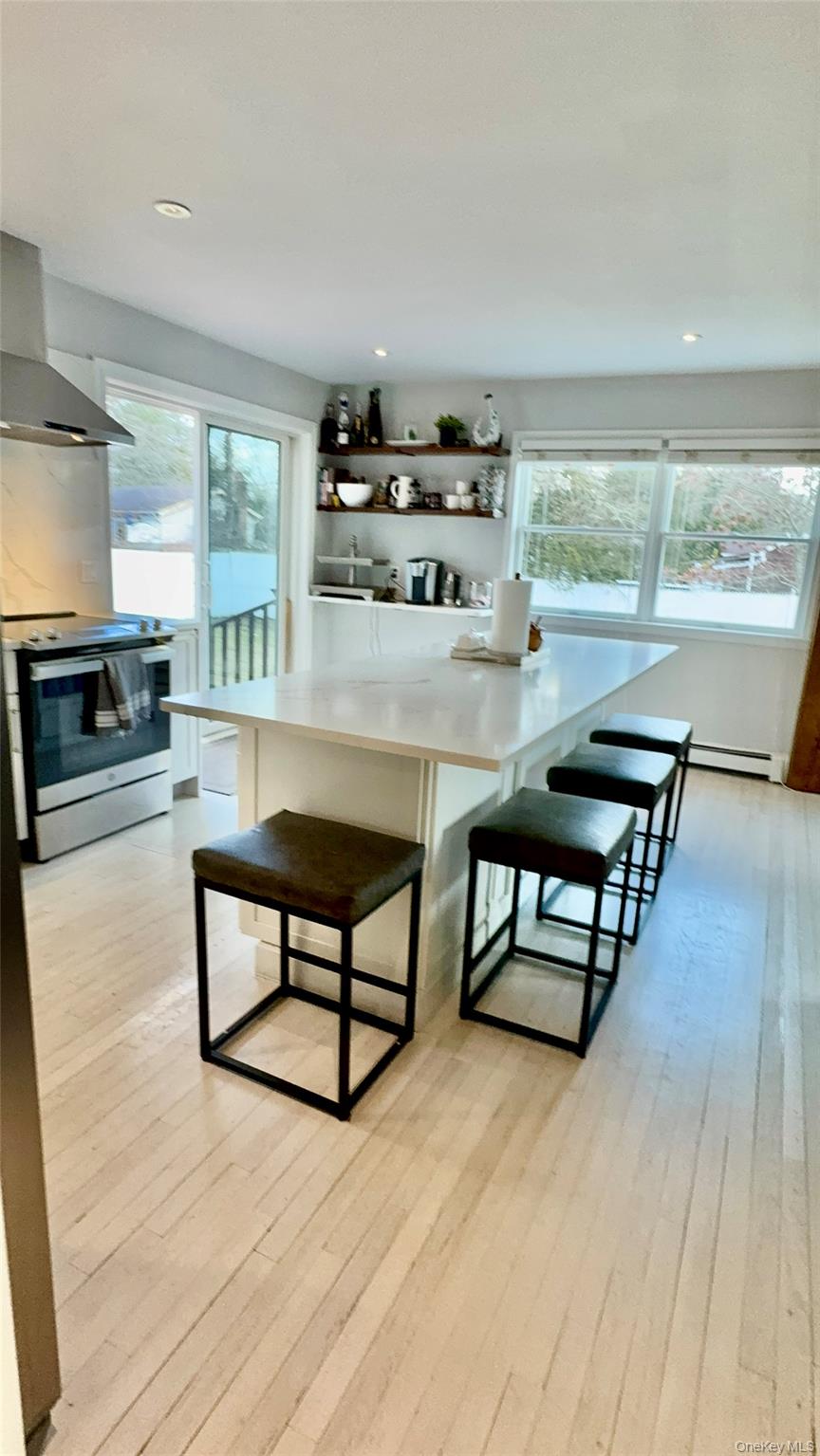 4 North Westbury Road Hampton Bays, NY 11946 - Photo 10 of 20 a living room with furniture and a flat screen tv
