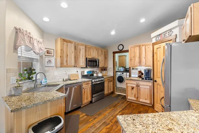a kitchen with a sink stove and refrigerator