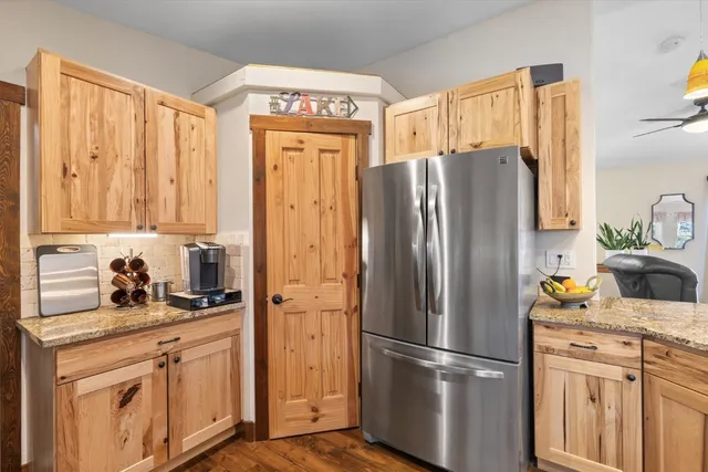a kitchen with stainless steel appliances a refrigerator sink and cabinets
