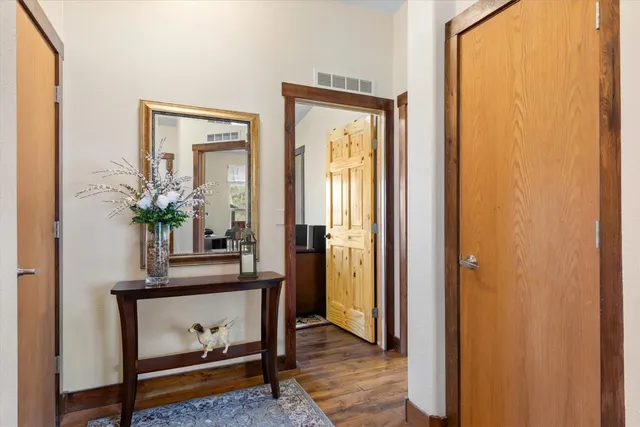 a view of hallway with mirror and furniture