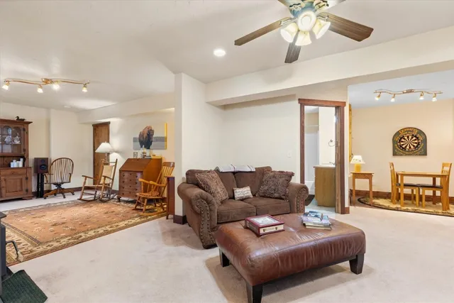 a living room with furniture and a large mirror