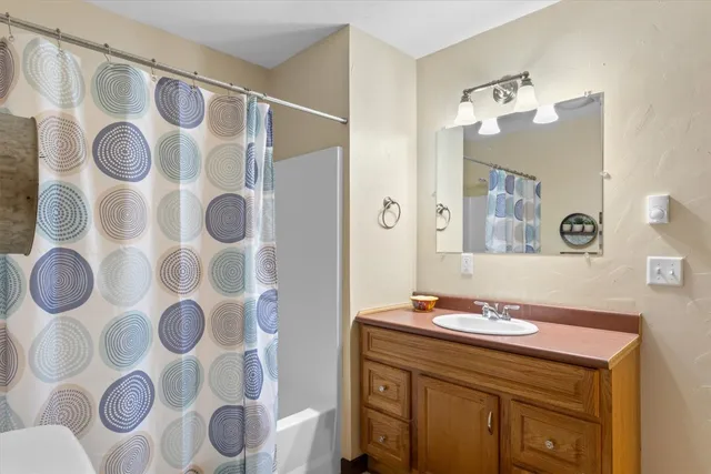 a bathroom with a sink and mirror