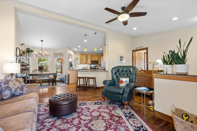 a living room with furniture a rug and a chandelier