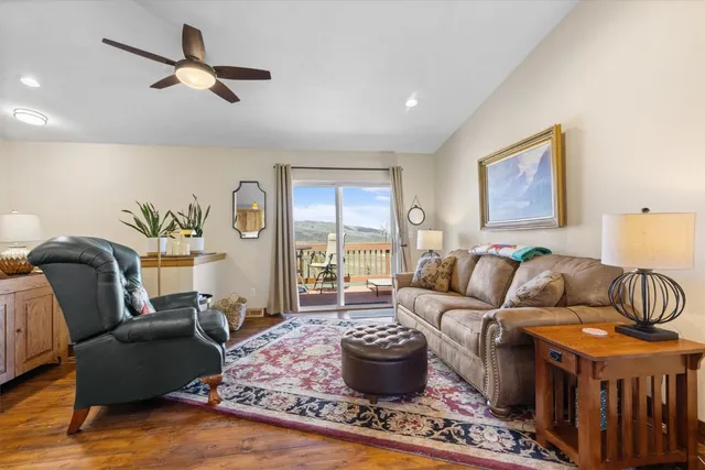 a living room with furniture ceiling fan and a rug