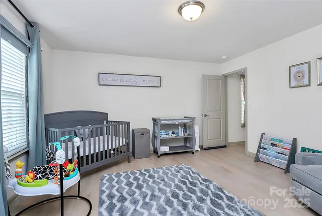 a bedroom with furniture and a baby crib