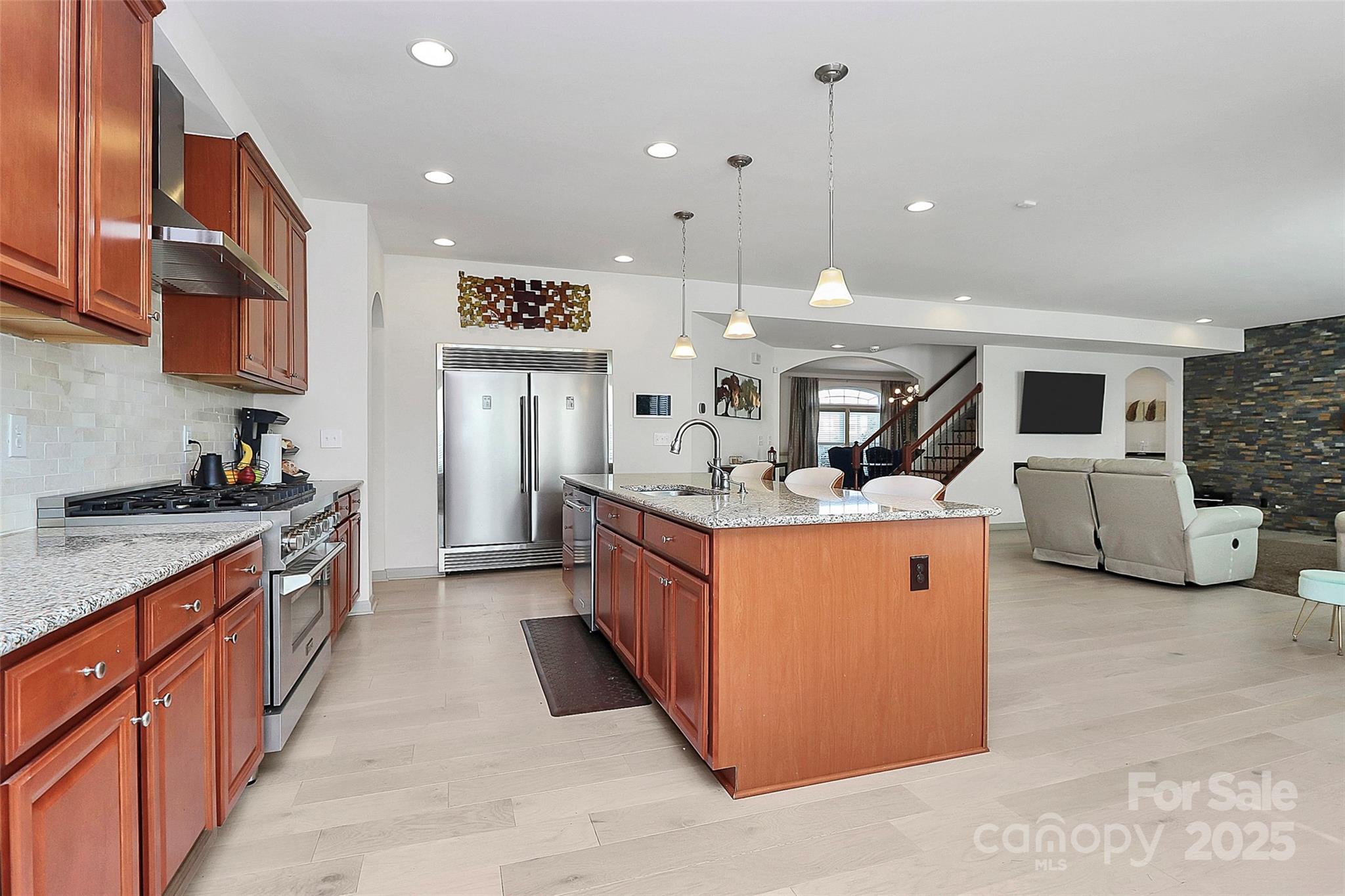 7362 Millstone Circle Southwest Concord, NC 28025 - Photo 3 of 45 a large kitchen with stainless steel appliances kitchen island granite countertop a large counter top and a stove top oven